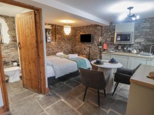 a kitchen and a bedroom with a bed in a room at Gwyn Studio in Aber-nant