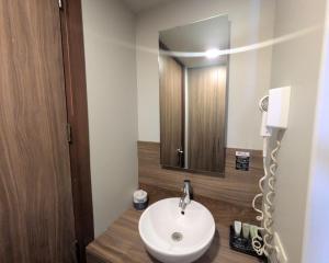 a bathroom with a white sink and a mirror at Hotel Block Suites in Mexico City +37 photos