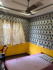 a bedroom with a bed and a window at Jsn Palace in Chennai