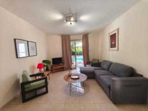 a living room with a couch and a table at Villa Arfa in Peyia