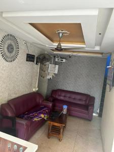 a living room with a couch and a table at Jsn Palace in Chennai