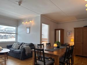 a living room with a table and a couch at Stay in the heart of Geilo, walk to everything in Geilo +23 photos