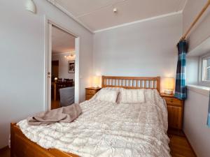 a bedroom with a bed and two lamps and a window at Stay in the heart of Geilo, walk to everything in Geilo