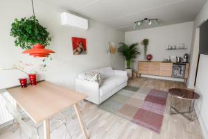 a living room with a white couch and a table at Pievos in Birštonas