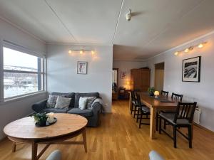 a living room with a couch and a table at Stay in the heart of Geilo, walk to everything in Geilo