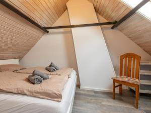 Dos camas en una habitación con techo de madera. en Holiday Home Helmrich by Interhome, en Schoondijke