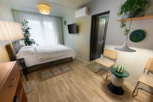 a bedroom with a bed and a table and chairs at Pievos in Birštonas
