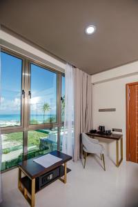 a room with a desk and a large window at Royal Villa Fulidhoo in Fulidhoo