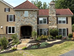 una casa con un edificio de piedra y un patio en Hidden Valley Estate, en Harrisburg