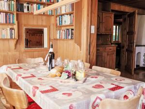 a table with a white table cloth and a bottle of wine at Chalet Chalet Pitschun by Interhome in Grindelwald