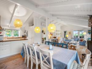 a kitchen and dining room with a table and chairs at Holiday Home Danko - 1-5km from the sea by Interhome in Fanø +20 photos