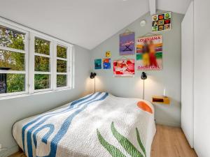 a bedroom with a bed and two windows at Holiday Home Teijo - 2-5km from the sea by Interhome in Ebeltoft
