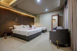 a hotel room with a bed and a chair at Royal Villa Fulidhoo in Fulidhoo +46 photos