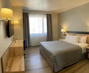 a hotel room with a bed and a window at Diego de Almagro Providencia Express in Santiago
