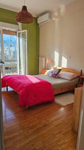 una camera da letto con un letto grande con una coperta rossa di Athenslander Acropolis view ad Atene