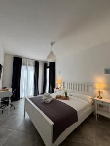 a bedroom with a large bed in a room at L'obiettivo in Assemini