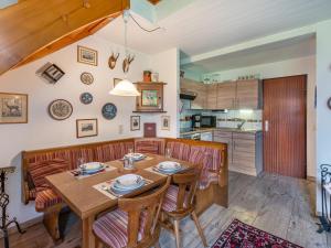 a kitchen and dining room with a wooden table and chairs at Holiday Home Landhaus Kunze by Interhome in Gröbming