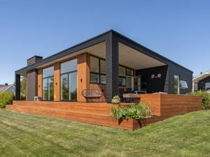a house with a large deck in the yard at Holiday Home Karitte - 300m from the sea by Interhome in Hvidbjerg
