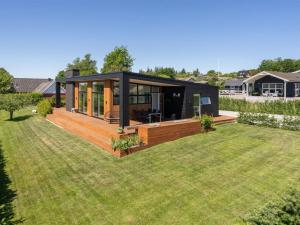a modern black house with a large yard at Holiday Home Karitte - 300m from the sea by Interhome in Hvidbjerg
