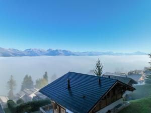 a house on a hill with a view of a lake at Chalet Etoile by Interhome in Nendaz