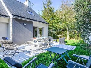 a patio with chairs and a table in the grass at Holiday Home Maison de l'Amaryllis by Interhome in Baden