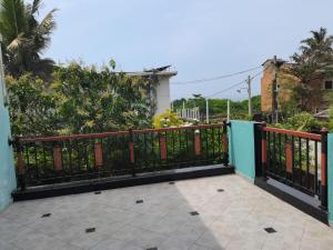 a fence in front of a house at Ceylon Traveller Homestay in Panadura