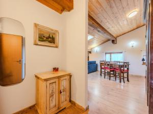 a dining room and living room with a table at Apartment Mansarda in Legno San Rocco by Interhome in Carisolo