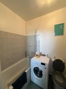 a bathroom with a washing machine and a toilet at Charming 2 room appartement in Paris