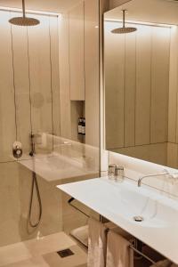 a bathroom with a sink and a mirror at Hotel Bécquer in Seville