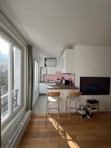 a kitchen with two chairs and a table in a room at Charming 2 room appartement in Paris