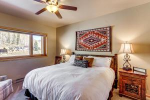 a bedroom with a bed with a ceiling fan and a window at Purgatory Resort Condo, Walk to the Chairlift in Durango +31 photos