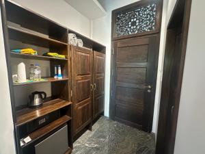 a hallway with wooden cabinets and a door at Niyagama House in Galle