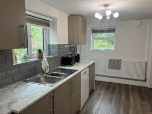 a kitchen with a sink and a counter top at Llangollen - House - Sleeps 7 - Garden in Glyn-Ceiriog
