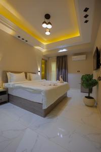 a bedroom with a large bed and a potted plant at Cairo soul Hotel in Cairo