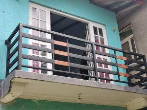 a balcony of a house with a window at Ceylon Traveller Homestay in Panadura +3 photos
