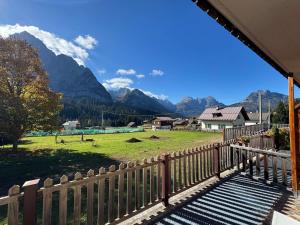 a balcony with a fence and mountains in the background at Siera Loft 1 - Panorama a 3 Minuti dalle Piste in Ecche