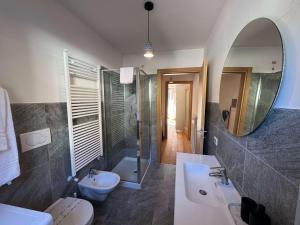 a bathroom with a sink and a toilet and a mirror at Siera Loft 1 - Panorama a 3 Minuti dalle Piste in Ecche +3 photos