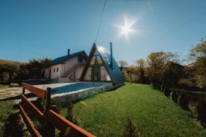 a house with a slide on the side of it at Brvnara BOGDAN in Kolašin