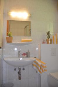 a bathroom with a white sink and a mirror at Ferienhäuser Tröster in Bad Kleinkirchheim +86 photos