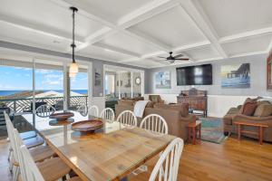a dining room and living room with a table and chairs at Queen Bee in Tybee Island