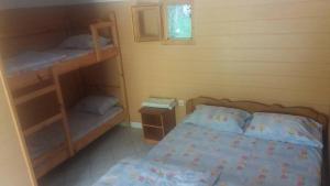 a bedroom with a bed and bunk beds in it at Holiday Park Tajoraft in Konjic