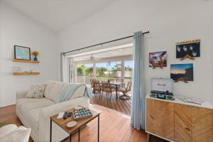 a living room with a couch and a table at Casa Al Mare in Sanibel Island