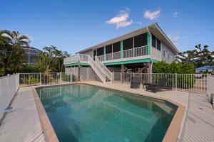 a house with a swimming pool in front of a house at Casa Al Mare in Sanibel Island