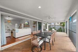 a dining room and living room with a table and chairs at Casa Al Mare in Sanibel Island
