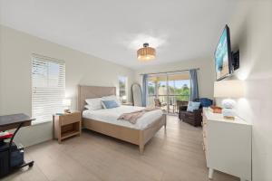 a bedroom with a bed and a desk and a chair at Casa Al Mare in Sanibel Island +78 photos