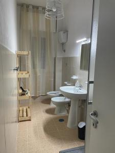 a bathroom with two toilets and a sink and a mirror at Casa Maria in Naples +17 photos