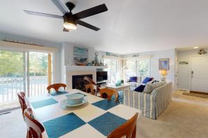 a living room with a table and a couch at Sea Colony - 56046 Pinewood Dr in Bethany Beach +47 photos