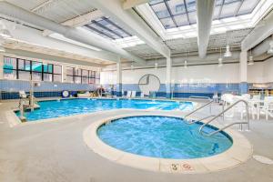 a large swimming pool with blue water in a building at Sea Colony - 56046 Pinewood Dr in Bethany Beach