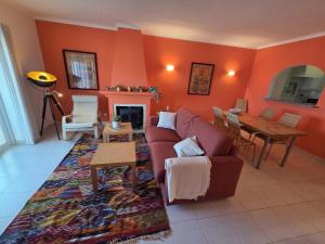 a living room with a couch and a table at CoolHouses Algarve Luz, Ramalhete in Luz
