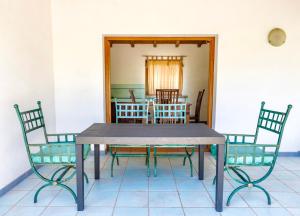a dining room table and chairs in a room at ISA - Residence with swimming pool in Badesi just 300 mt from the sea in Badesi
